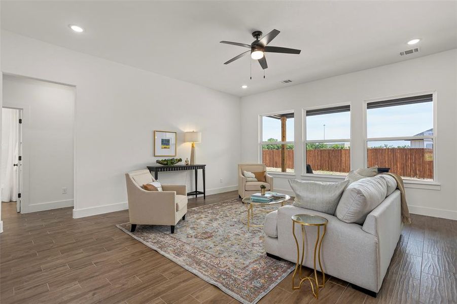 Living room featuring dark hardwood / wood-style flooring and ceiling fan