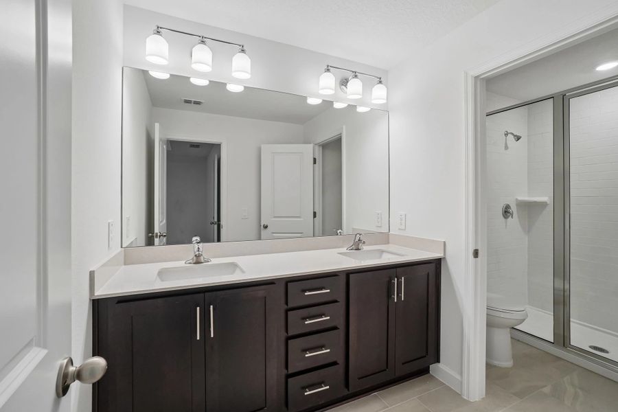 Primary bathroom features double sinks and a walk-in shower Primary bathroom features double sinks and a walk-in shower