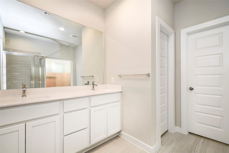 Escape to a spa-like oasis in this primary bathroom. Enjoy a walk-in showerwith tile surround, a separate garden tub with custom detailing, and an elegantvanity featuring light countertops, modern hardware, and beautiful recessed lights.Experience luxury and relaxation in every detail. Sample photo of completed home with similar floor plan. Actual colors and selections may vary. Escape to a spa-like oasis in this primary bathroom. Enjoy a walk-in showerwith tile surround, a separate garden tub with custom detailing, and an elegantvanity featuring light countertops, modern hardware, and beautiful recessed lights.Experience luxury and relaxation in every detail. Sample photo of completed home with similar floor plan. Actual colors and selections may vary.