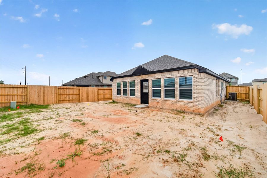 Exterior details and patio area of a home in Sunterra, Katy (Image 29).