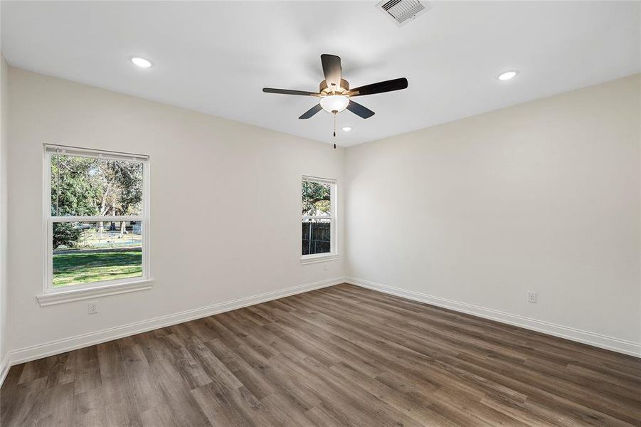 Spare room with dark wood-style floors, recessed lighting, and a ceiling fan Spare room with dark wood-style floors, recessed lighting, and a ceiling fan
