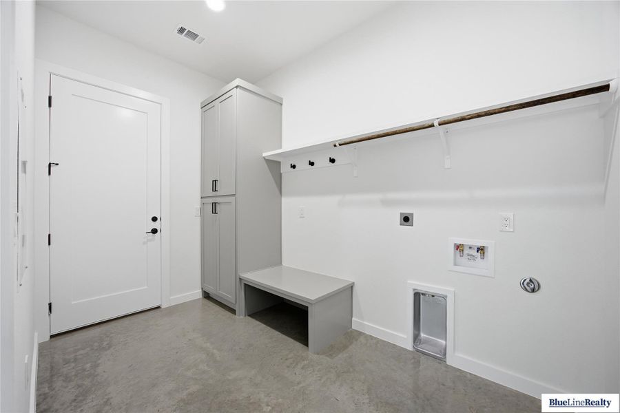 Laundry room featuring finished concrete floors, electric dryer hookup, and hookup for a washing machine