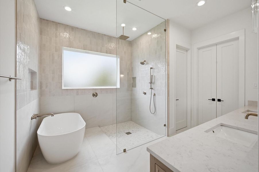 Spa-inspired primary bath showcases a soaking tub and oversized shower.