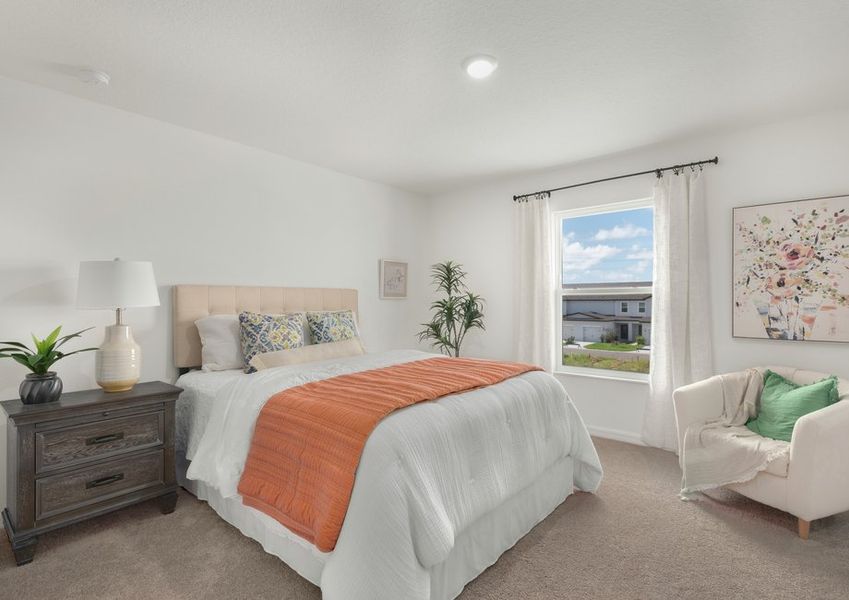 A large picture window lets in plenty of natural light to this master bedroom.