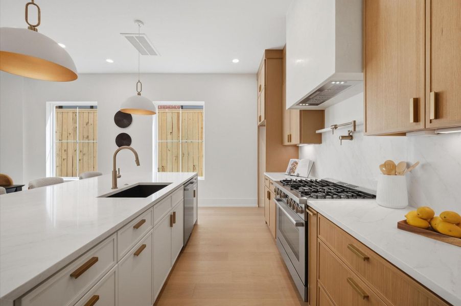 Chef's kitchen offers premium appliances, pot filler and ample storage.
