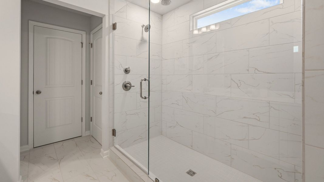 Primary bathroom with glass enclosed shower with shower window Primary bathroom with glass enclosed shower with shower window