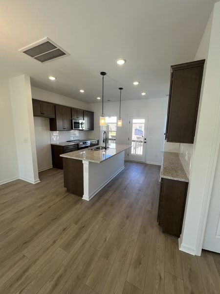 Granite countertops and Umber Birch cabinets