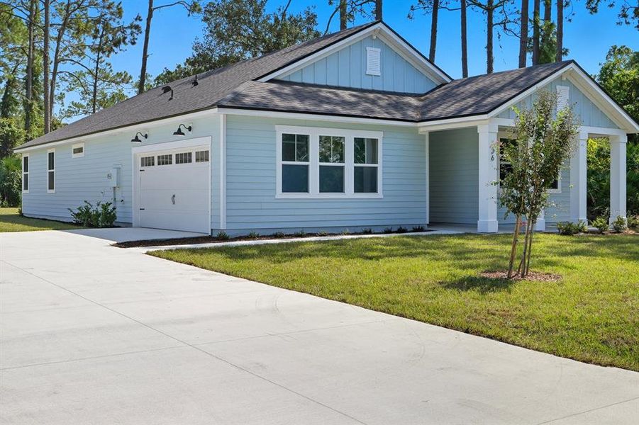 Front exterior of a new home in Palm Coast Homes, Palm Coast, FL, highlighting curb appeal (Image 1).