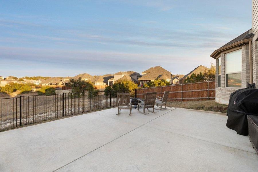 Fenced backyard with a residential view, a patio, and grilling area Fenced backyard with a residential view, a patio, and grilling area