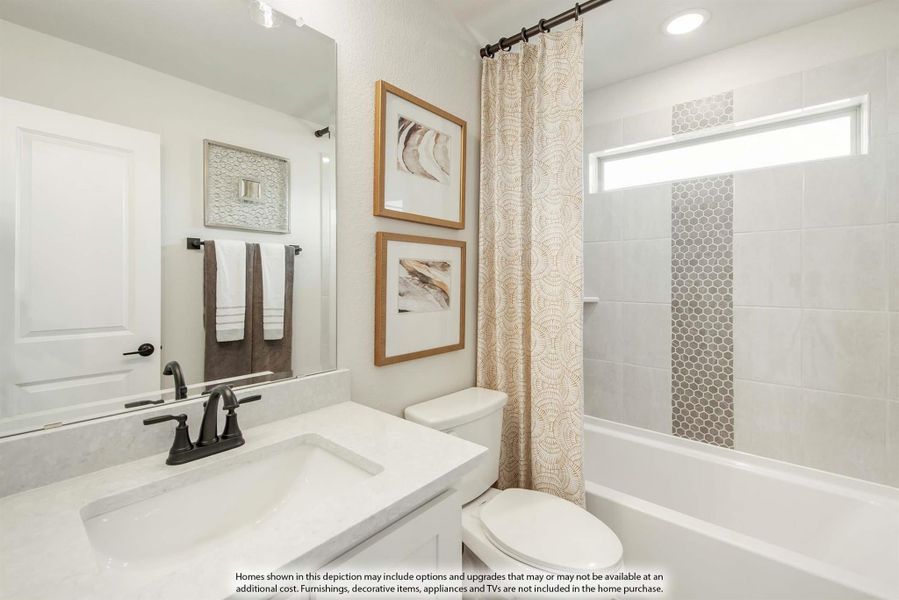 Bathroom with white vanity, tub-shower combo with tile surround, and large mirror