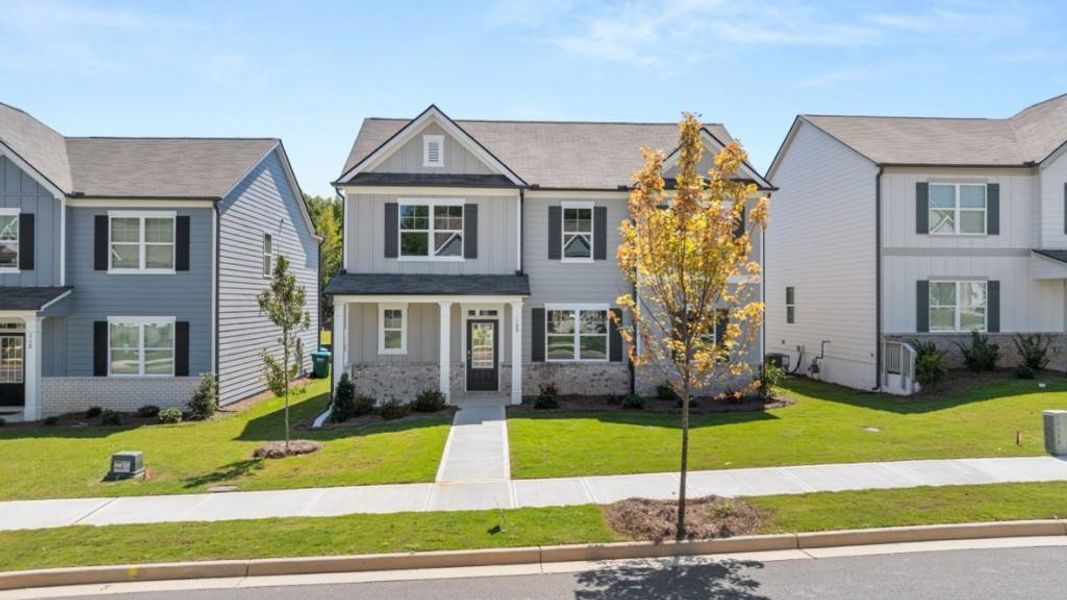 Front exterior of a new home in Braselton Village, Braselton, GA, highlighting curb appeal (Image 12). Front exterior of a new home in Braselton Village, Braselton, GA, highlighting curb appeal (Image 12).