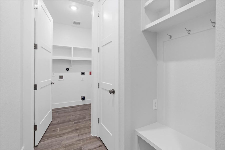 This space efficiently combines a dedicated laundry room area, complete with hookups and ample open shelving for supplies, with a separate mudroom transition zone. This space efficiently combines a dedicated laundry room area, complete with hookups and ample open shelving for supplies, with a separate mudroom transition zone.