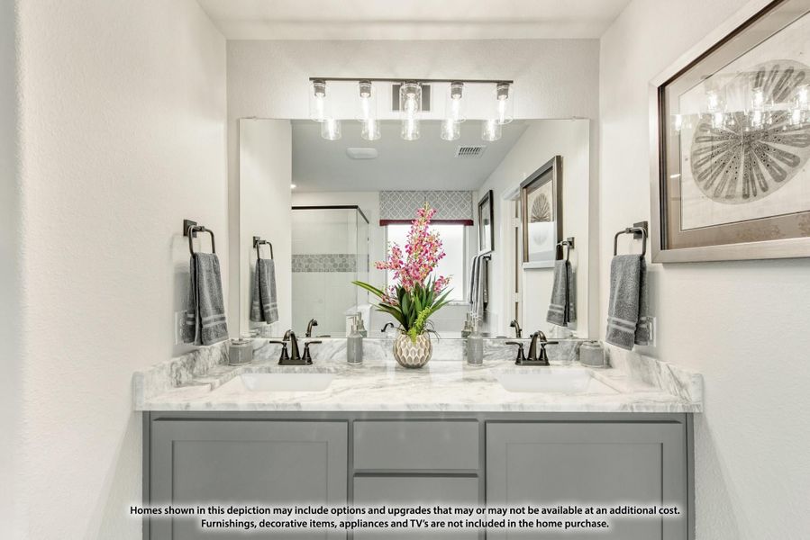 Bathroom with double sink vanity, gray cabinets, marble countertop, and large mirror with overhead lighting Bathroom with double sink vanity, gray cabinets, marble countertop, and large mirror with overhead lighting