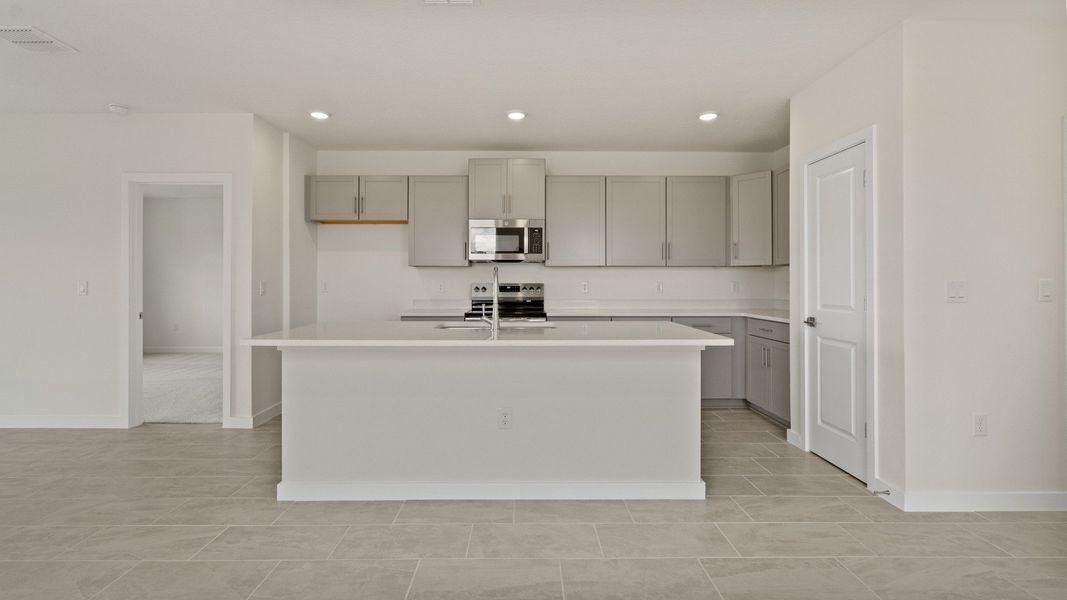 The Naples Kitchen with large Island Quick Move-In Home at Willowbrook North by DRB Homes in Winter Haven, FL The Naples Kitchen with large Island Quick Move-In Home at Willowbrook North by DRB Homes in Winter Haven, FL
