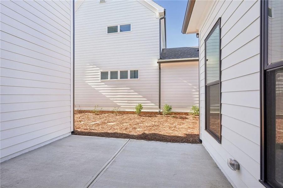 Exterior details and patio area of a home in Promenade at Sawnee Village, Cumming (Image 25).