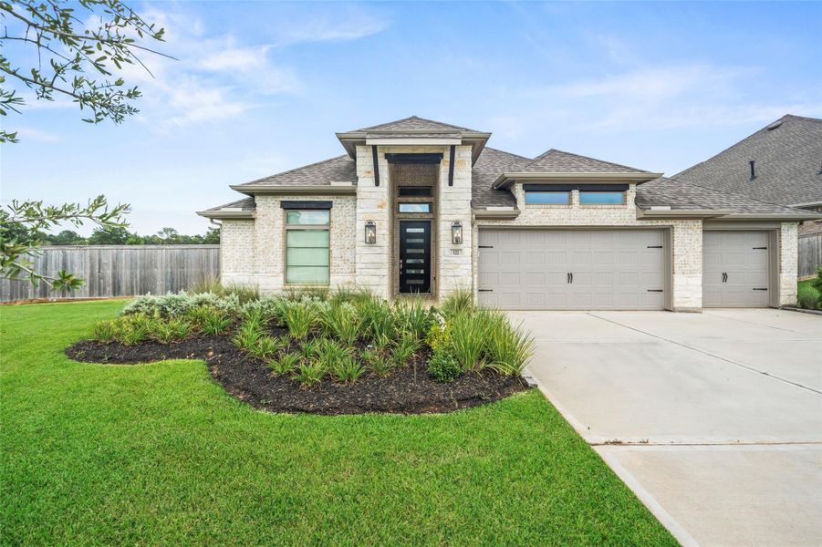 Front exterior of a new home in The Woodlands Hills 60', Willis, TX, highlighting curb appeal (Image 17). Front exterior of a new home in The Woodlands Hills 60', Willis, TX, highlighting curb appeal (Image 17).