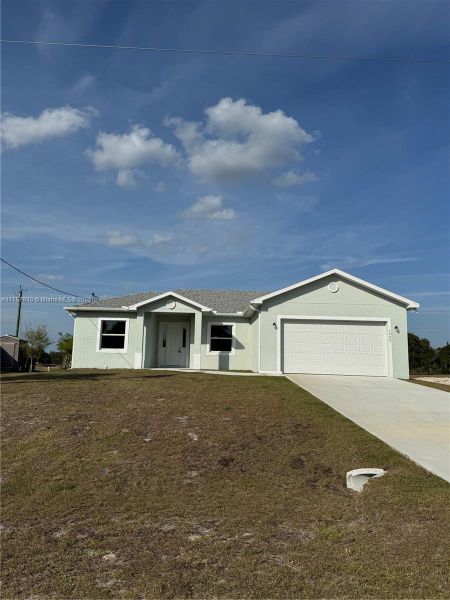 Front exterior of a new home in , Labelle, FL, highlighting curb appeal (Image 12).