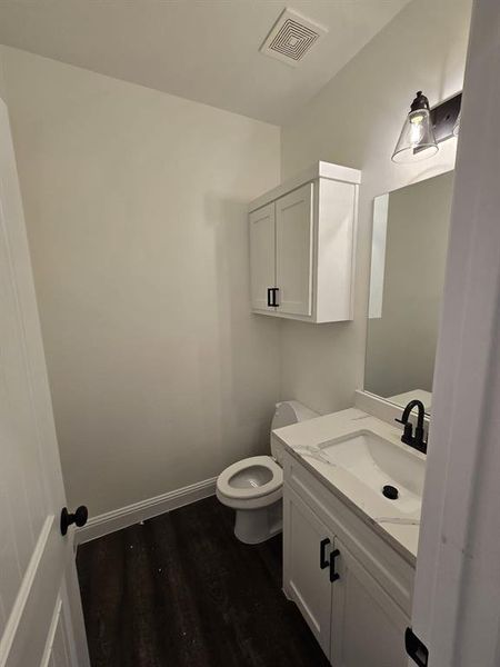 Bathroom featuring toilet, hardwood / wood-style flooring, and vanity