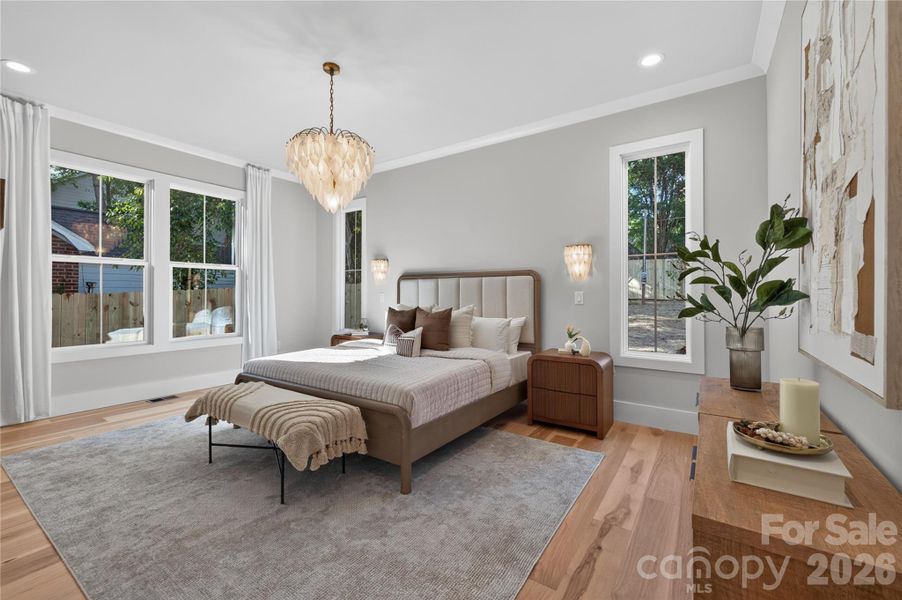 Primary suite with and matching sconces striking bespoken light fixture with matching sconces, recessed lighting.