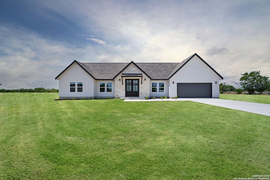 Front exterior of a new home in , Natalia, TX, highlighting curb appeal (Image 2).