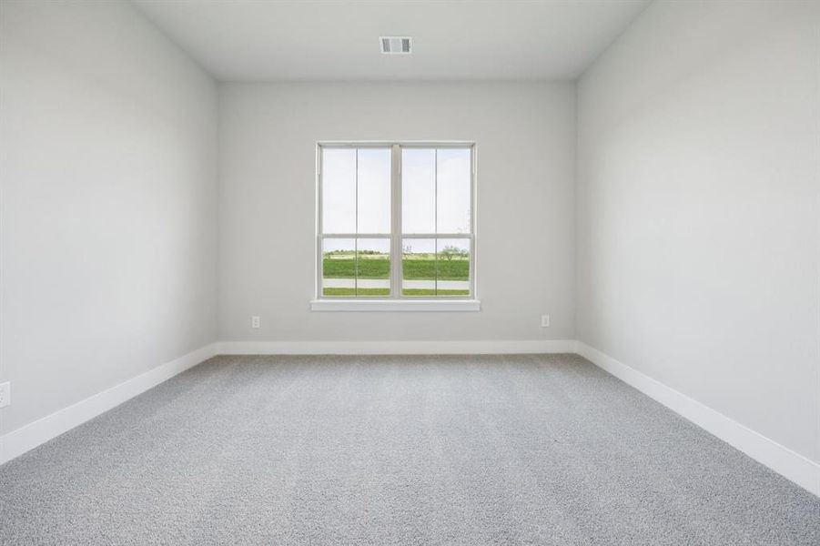 Unfurnished room featuring light colored carpet and baseboards