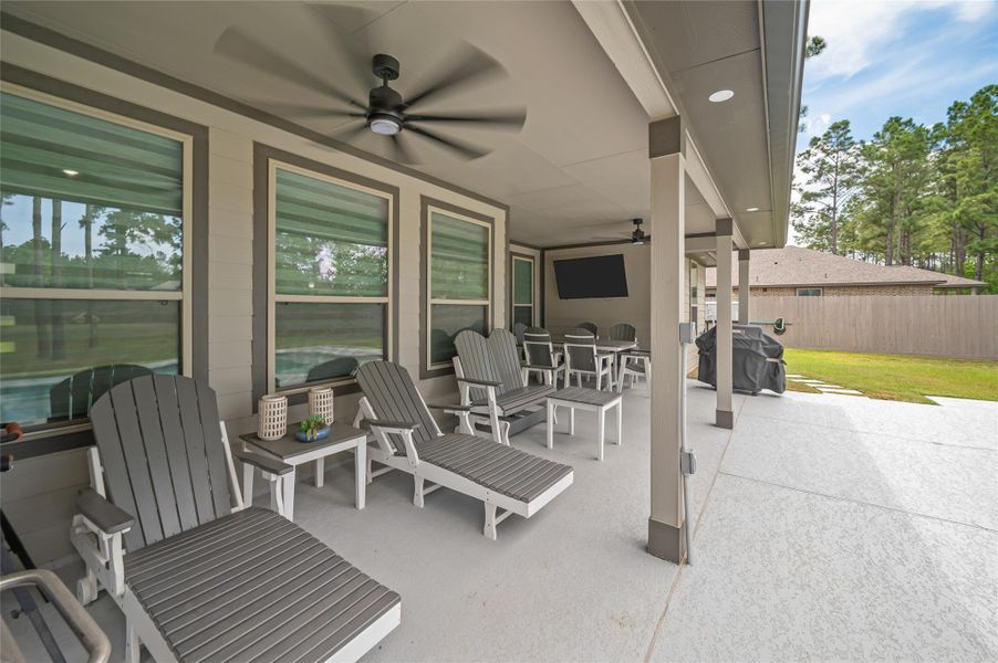 Extended covered porch and patio with dual fans and plenty of space to entertain.