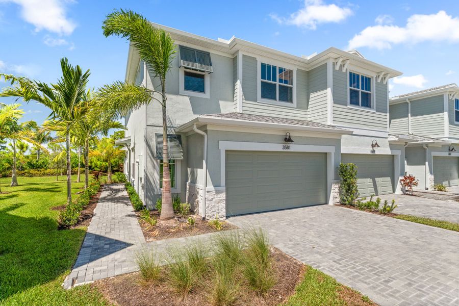 Front exterior of a new home in Avila, Jensen Beach, FL, highlighting curb appeal (Image 1).