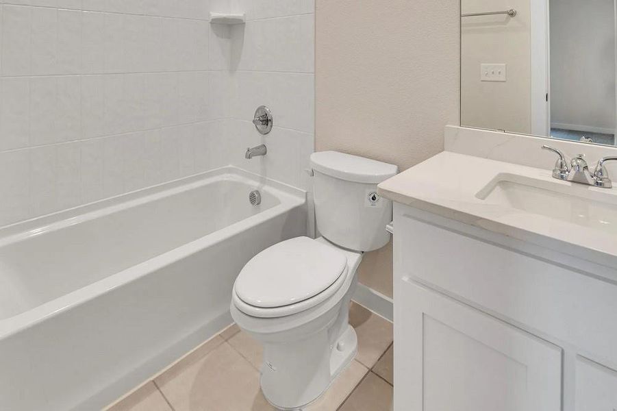 Bathroom featuring vanity, shower combination, and tile patterned floors Bathroom featuring vanity, shower combination, and tile patterned floors