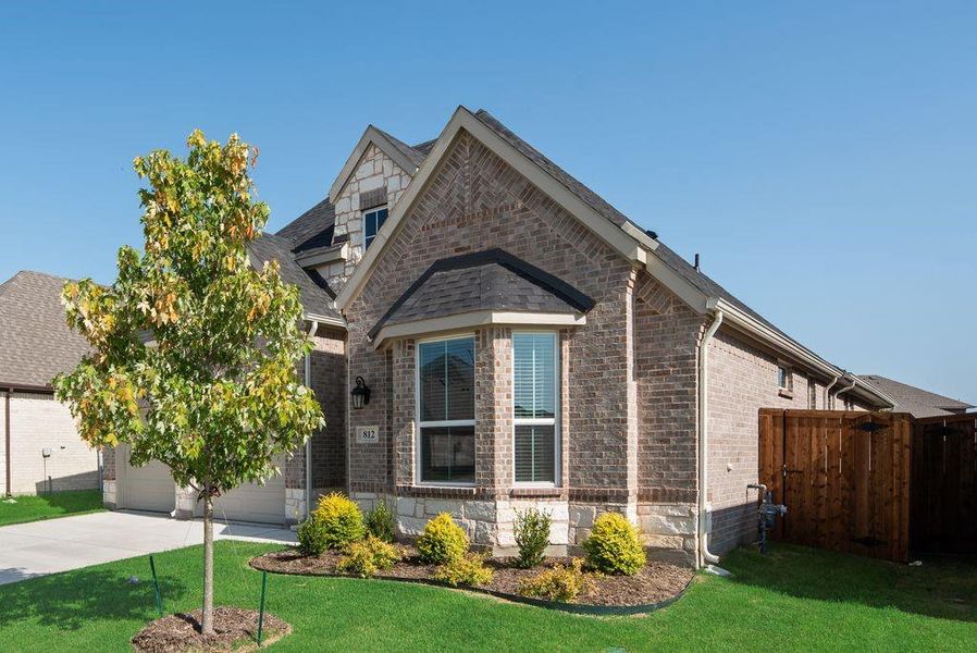 Front exterior of a new home in Wildflower Ranch, Justin, TX, highlighting curb appeal (Image 20). Front exterior of a new home in Wildflower Ranch, Justin, TX, highlighting curb appeal (Image 20).