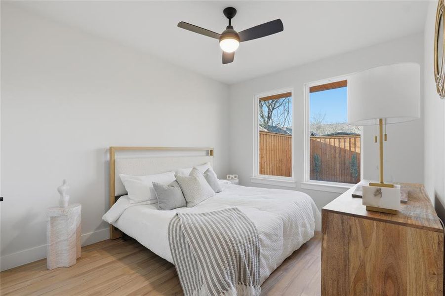 Bedroom featuring light wood-style floors and ceiling fan Bedroom featuring light wood-style floors and ceiling fan