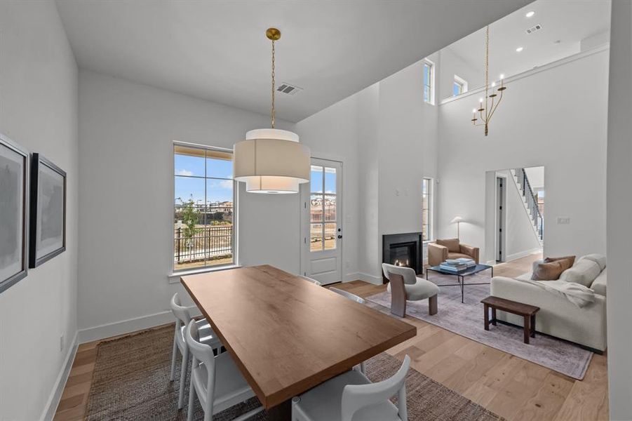 Dining space featuring hardwood / wood-style flooring and a high ceiling