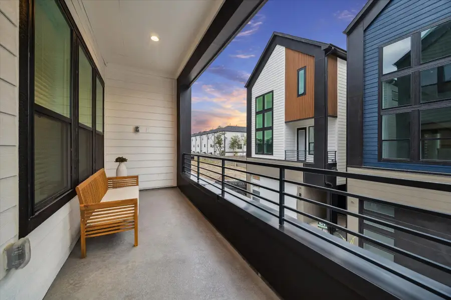 Covered balcony with modern black railing and recessed lighting, offering a peaceful outdoor space perfect for morning coffee or relaxing evenings with sunset views. Covered balcony with modern black railing and recessed lighting, offering a peaceful outdoor space perfect for morning coffee or relaxing evenings with sunset views.