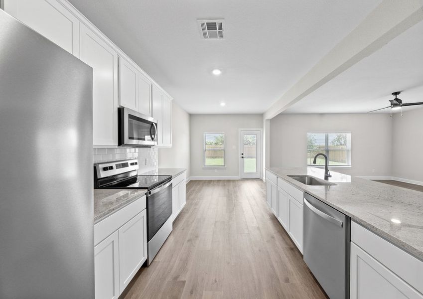 The kitchen of the Cypress has gorgeous white good cabinetry.