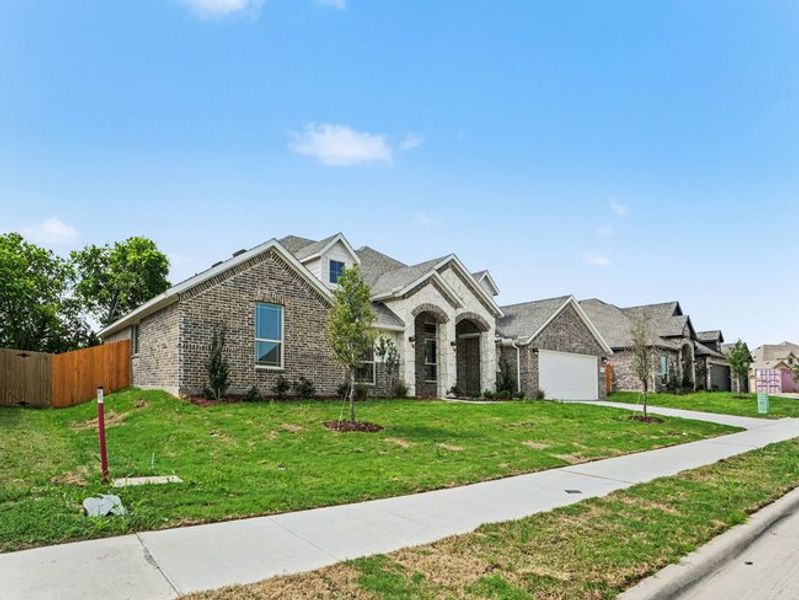 Front exterior of a new home in Cole Crossing Estates, DeSoto, TX, highlighting curb appeal (Image 21).