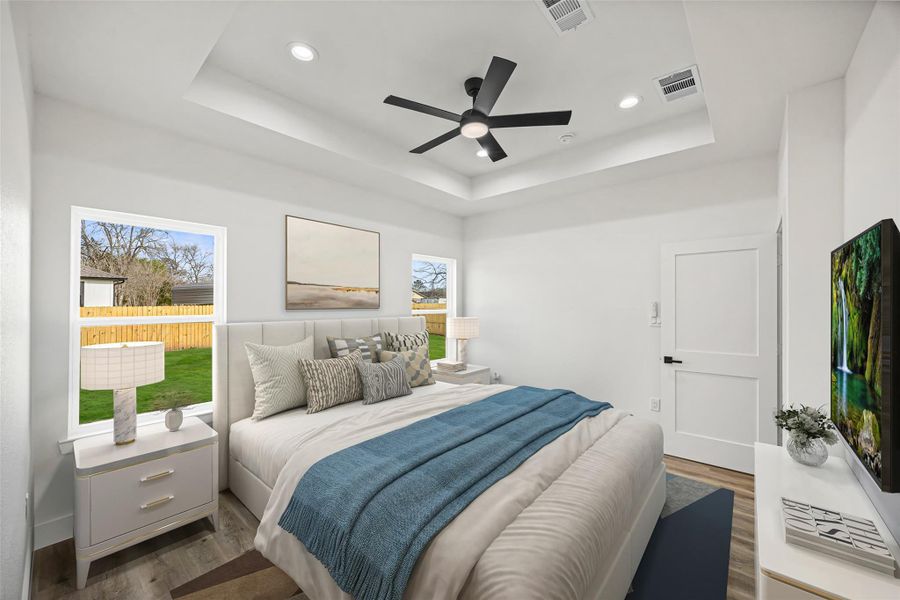 Light-filled primary suite with generous wall space and modern trim details.