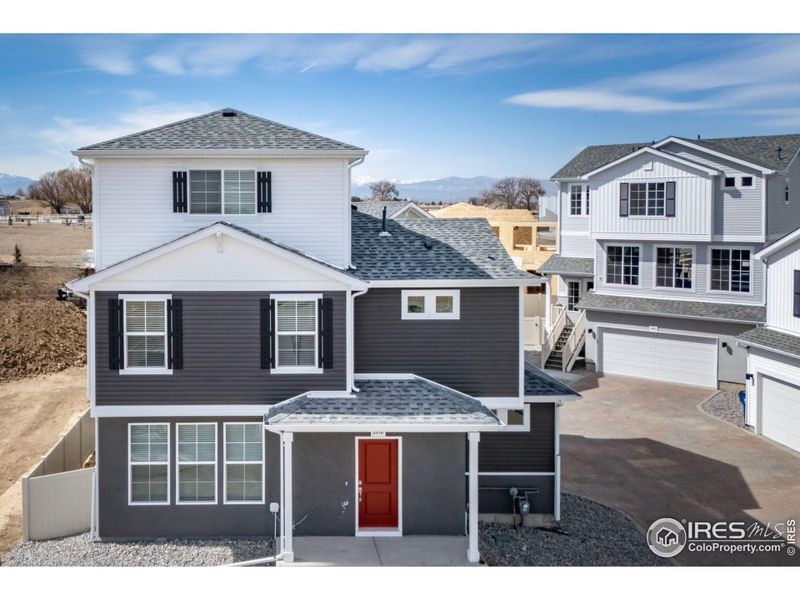 Front exterior of a new home in Thompson River Ranch, Johnstown, CO, highlighting curb appeal (Image 1). Front exterior of a new home in Thompson River Ranch, Johnstown, CO, highlighting curb appeal (Image 1).