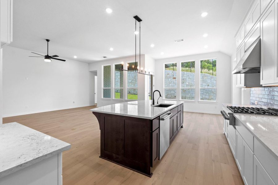Kitchen featuring light wood-style flooring, dark brown cabinetry, recessed lighting, ceiling fan, and white cabinets