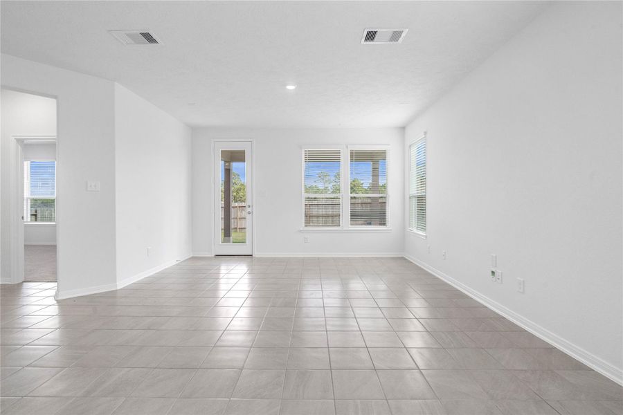 Bring family and friends together in this beautiful Great Room! It features soaring ceilings, recessed lighting, custom paint, tile flooring, and large windows that fill the space with natural light all day long.