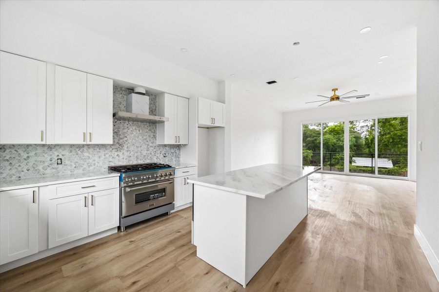 Stunning kitchen showcasing a ZLINE dual-fuel range with vent hood, complemented by gorgeous dolomite countertops.