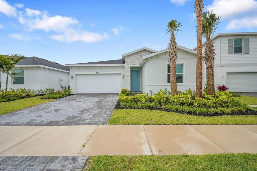 Front exterior of a new home in Seagrove: The Indies, Fort Pierce, FL, highlighting curb appeal (Image 16). Front exterior of a new home in Seagrove: The Indies, Fort Pierce, FL, highlighting curb appeal (Image 16).