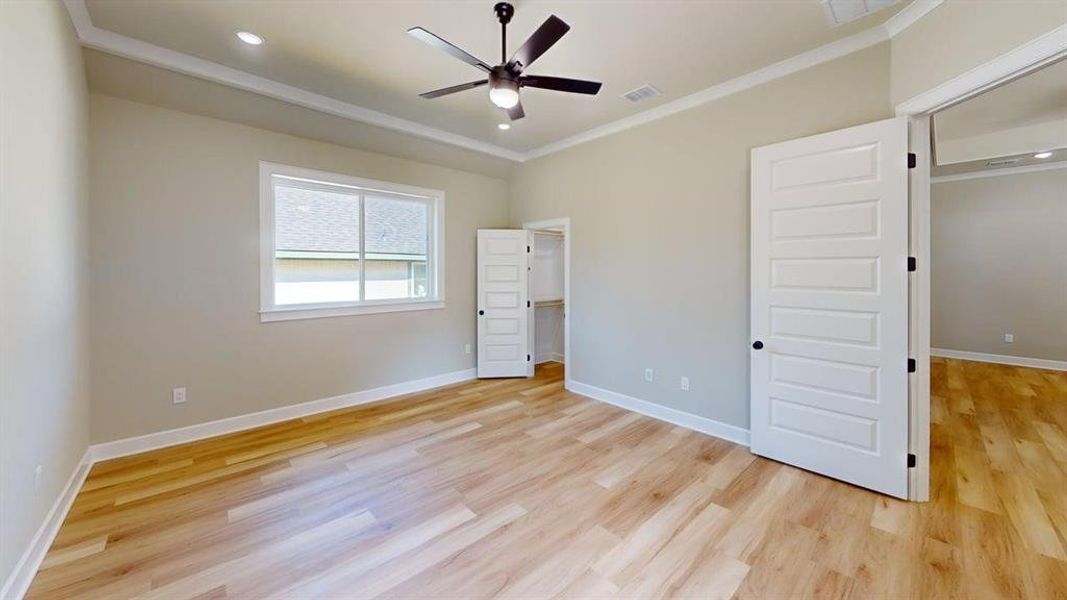 Unfurnished bedroom featuring light wood-type flooring, ornamental molding, baseboards, recessed lighting, and a ceiling fan