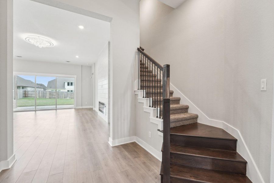 Stairway featuring baseboards, wood finished floors, and recessed lighting Stairway featuring baseboards, wood finished floors, and recessed lighting