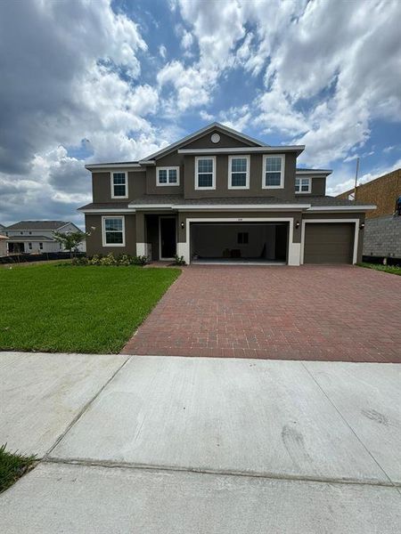 Front exterior of a new home in Park View at the Hills, Clermont, FL, highlighting curb appeal (Image 1).