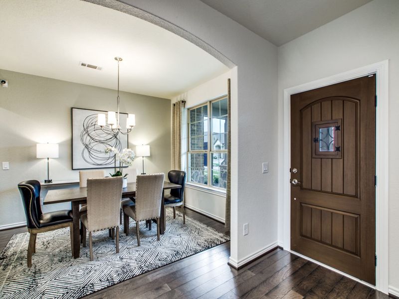 Welcoming entryway with dining room