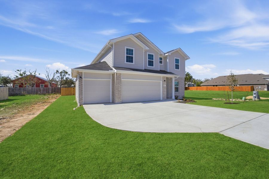 Front exterior of a new home in Grande Estates, Bertram, TX, highlighting curb appeal (Image 25).