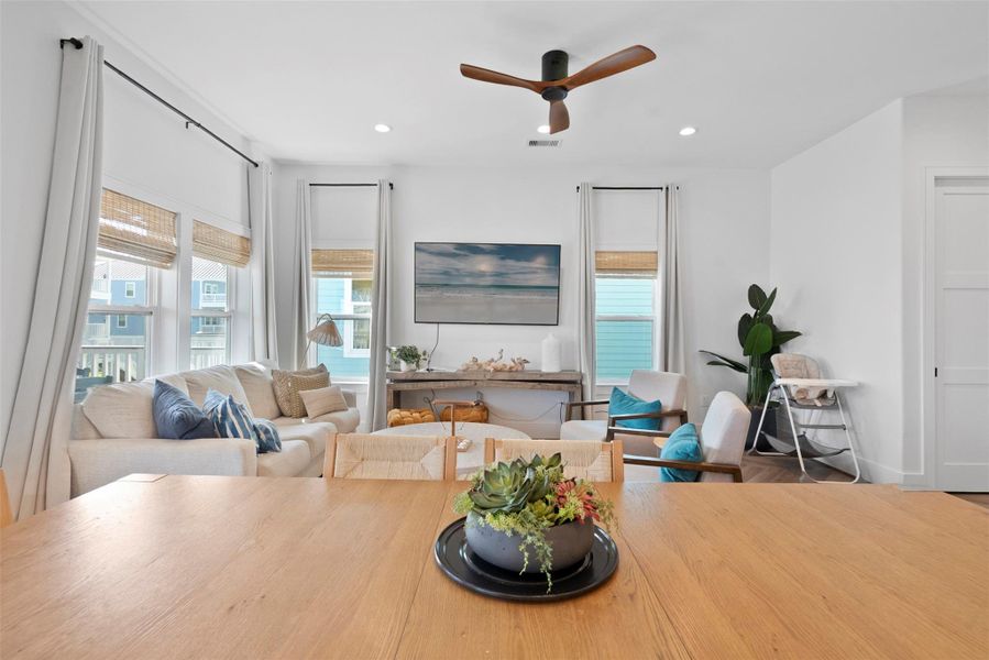 Looking out from the dining area, a soft palette and airy design lead the eye to the relaxed living room. The tabletop awaits your personal touch—consider a simple centerpiece to echo the calm, modern vibe of the space. Looking out from the dining area, a soft palette and airy design lead the eye to the relaxed living room. The tabletop awaits your personal touch—consider a simple centerpiece to echo the calm, modern vibe of the space.