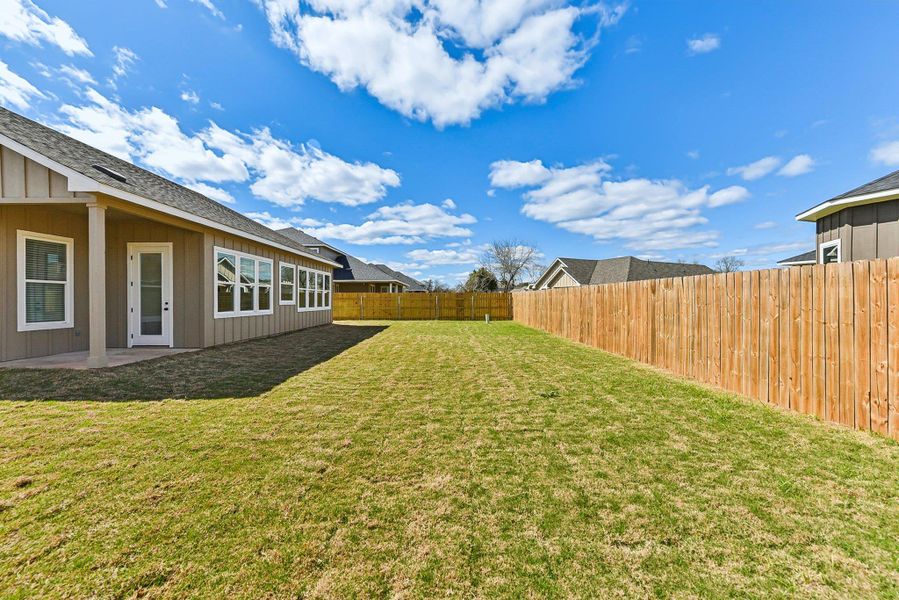 View of yard featuring a patio and a fenced backyard View of yard featuring a patio and a fenced backyard