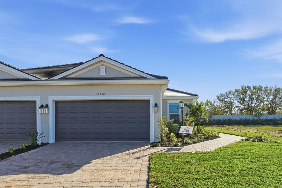 Front exterior of a new home in Esplanade at Azario Lakewood Ranch, Lakewood Ranch, FL, highlighting curb appeal (Image 1). Front exterior of a new home in Esplanade at Azario Lakewood Ranch, Lakewood Ranch, FL, highlighting curb appeal (Image 1).