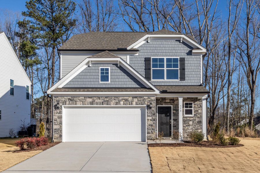 Front exterior of a new home in Daniel Farms, Benson, NC, highlighting curb appeal (Image 1). Front exterior of a new home in Daniel Farms, Benson, NC, highlighting curb appeal (Image 1).
