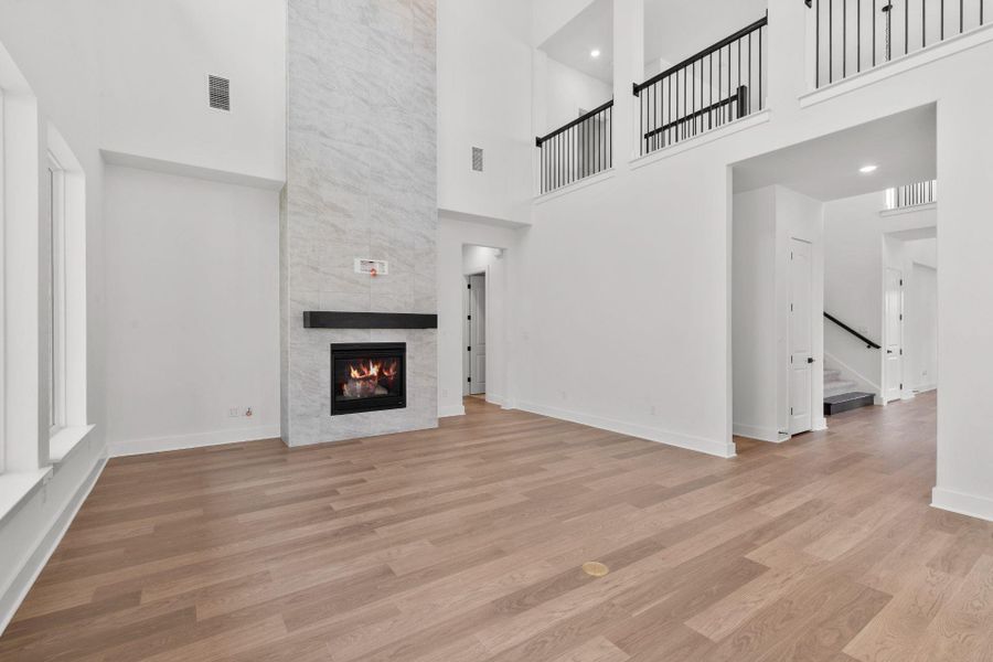 Family Room with soaring ceiling & fireplace
